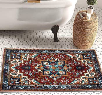 bath mat on tile floor that looks like a miniature version of a classic oriental rug