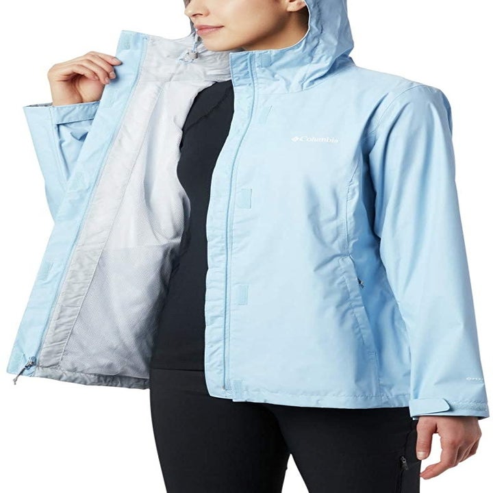 a model wearing the coat in light blue