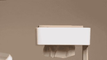 gif of person filling the upside down tissue holder stand