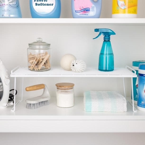 a stackable shelf holding laundry essentials