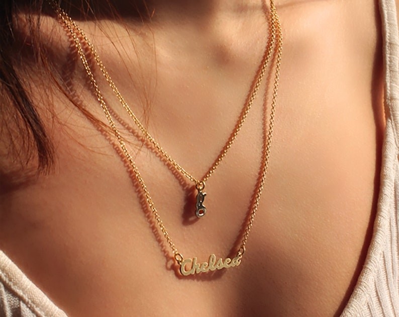model wearing a chain necklace with the name Chelsea in cursive
