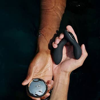 Models holding black prostate massager and wireless remote