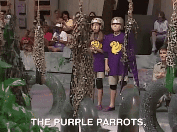 Two contestants on the show wear gold helmets and cheer before starting an obstacle course. The words &quot;The purple parrots&quot; appear before them in meme form