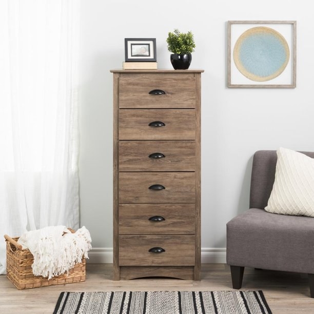 a tall dresser with six drawers in a room