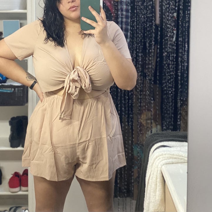 another reviewer taking a mirror selfie of themselves wearing the tan colored version