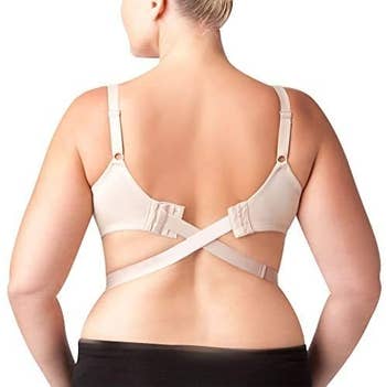 model wearing the converter with the straps crisscrossing in an X shape on their lower back