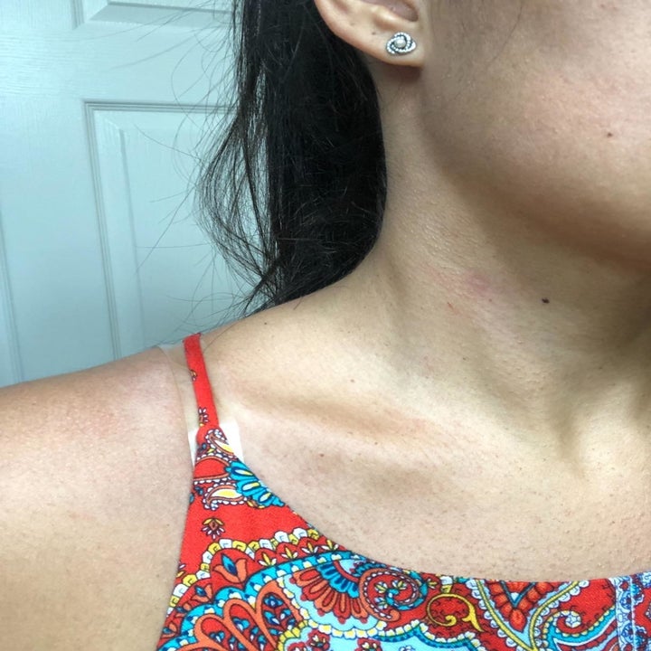 reviewer with the shoulder strap pulled up on their shoulder over the clear bra strap, and you can barely see the clear strap