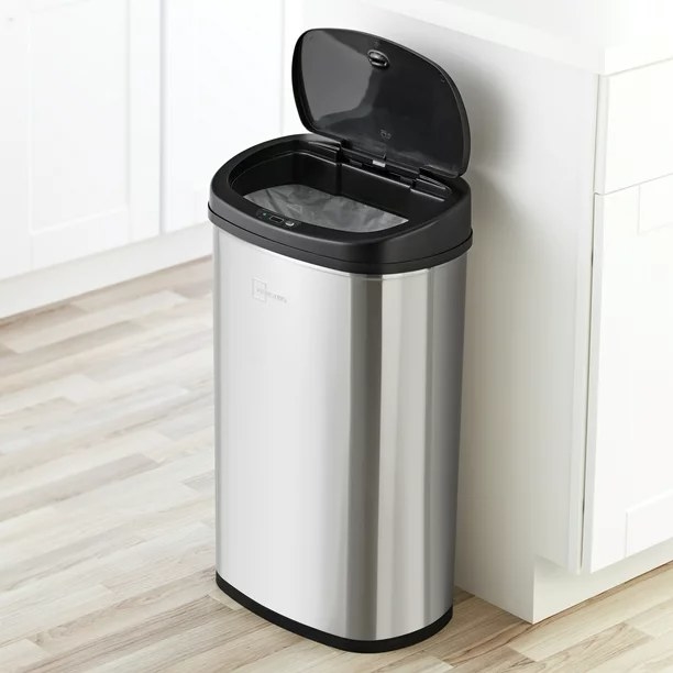 The motion sensor garbage can with the lid open in a kitchen