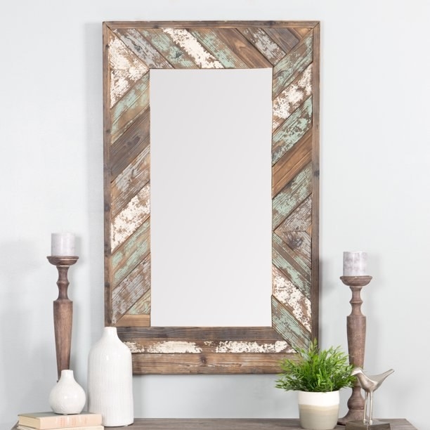 The rectangular mirror with distressed details in an entryway