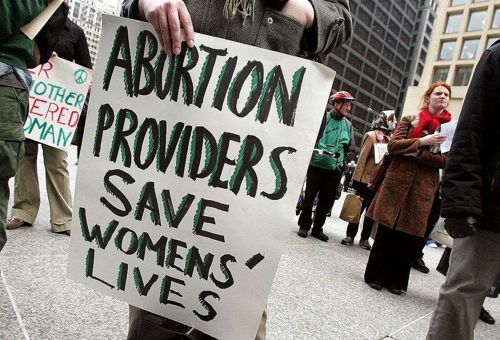 sign saying &quot;abortion providers save womens&#x27; lives&quot;