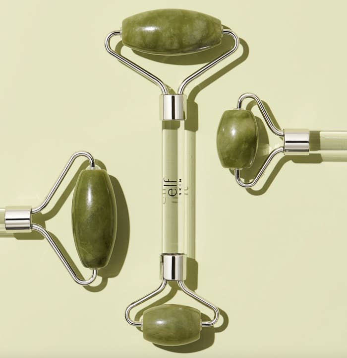 A set of three green jade rollers with a small and large end