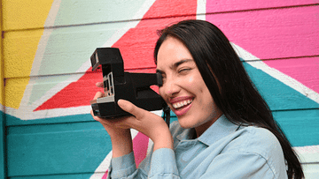 girl taking a polaroid picture