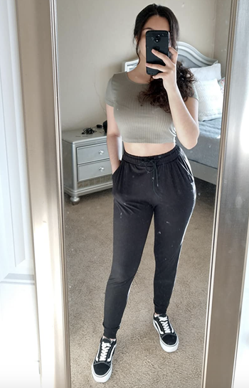 Reviewer in high-waisted black drawstring joggers