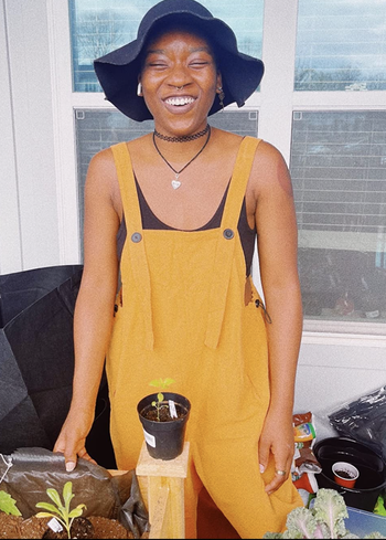 reviewer in gold bib overalls 