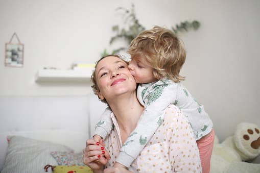 Young child hugging mom.