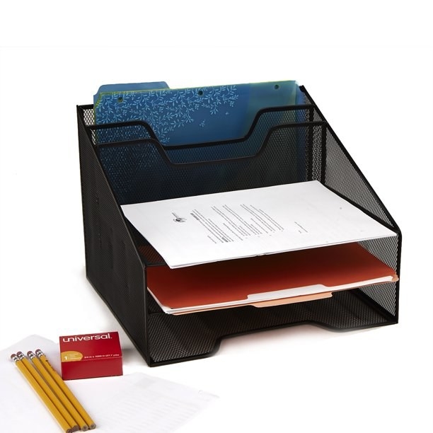 a mesh desk organizer filled with papers