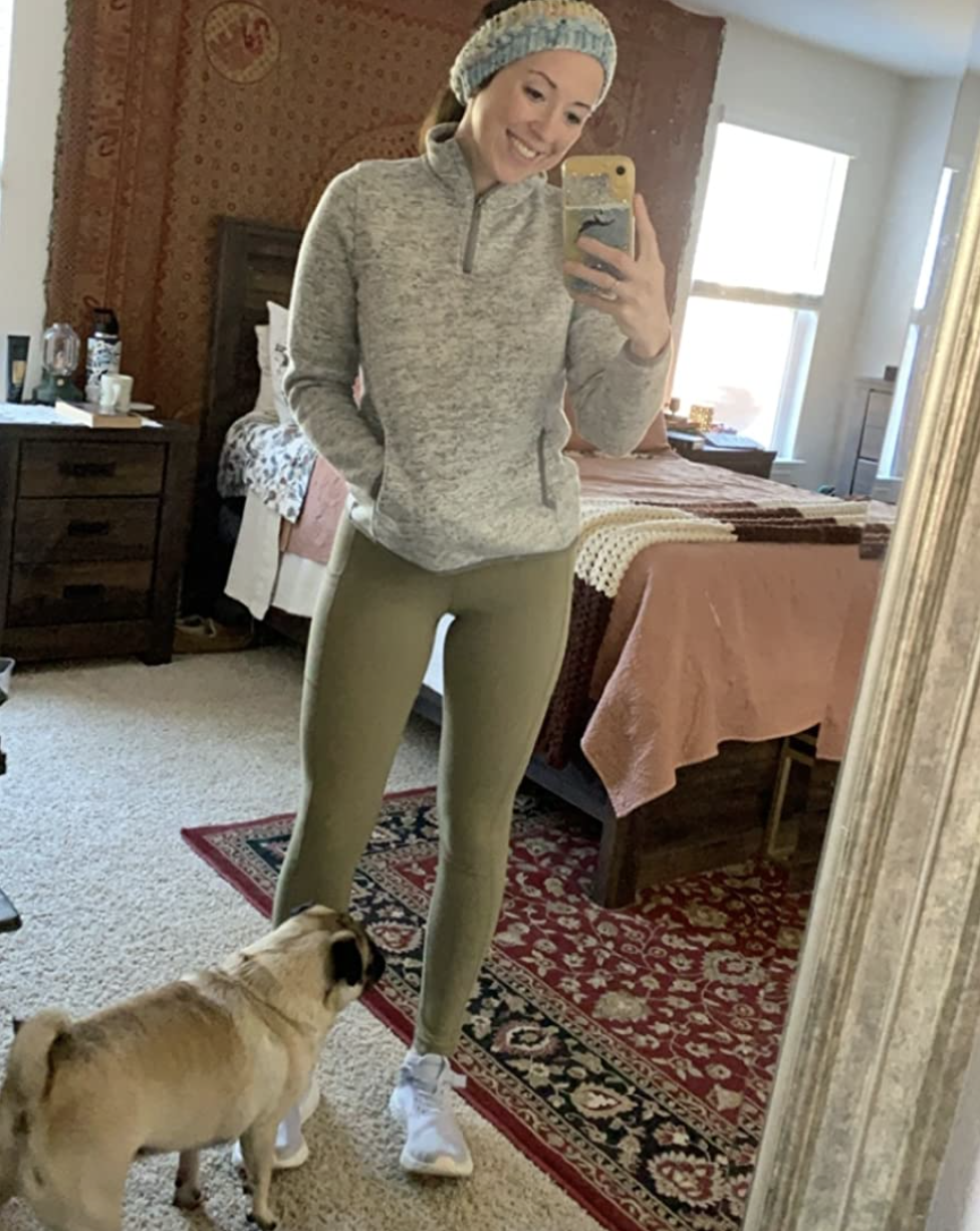 Reviewer in green leggings and workout gear
