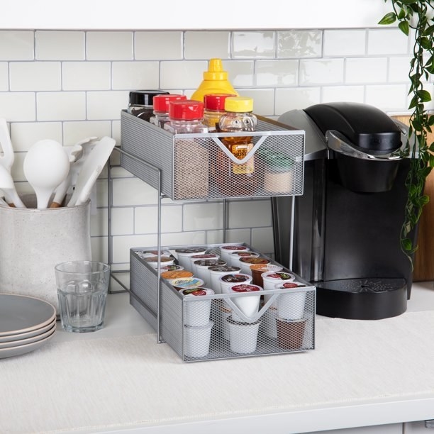 a metal sliding drawer set next to a coffee maker