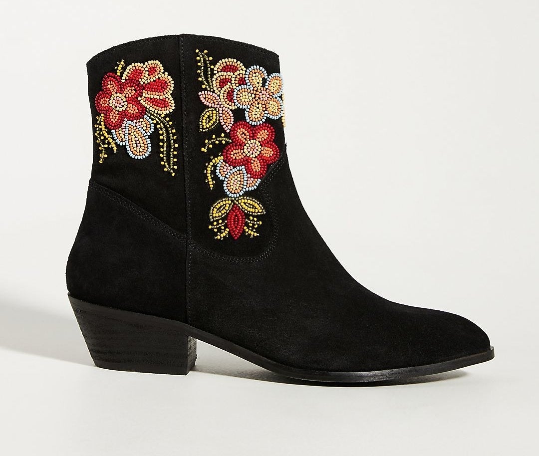 black boot with beaded flower on it