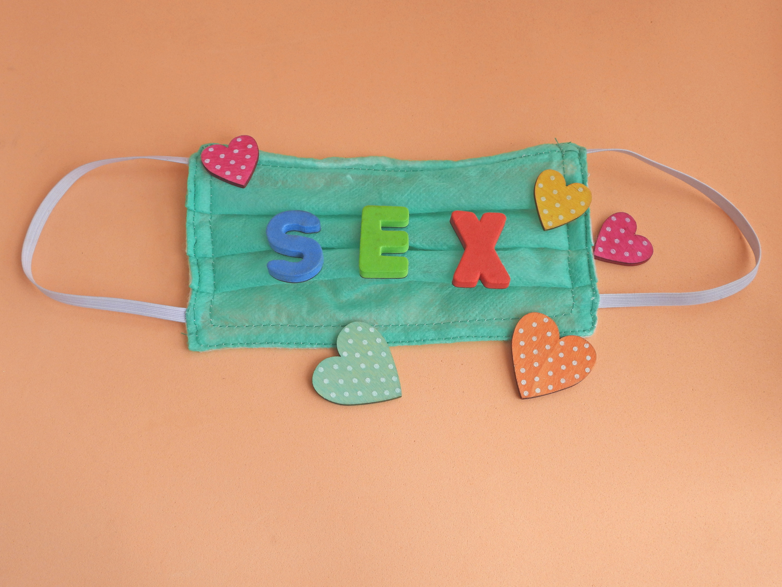 A medical mask covered in letters spelling out &quot;Sex&quot;