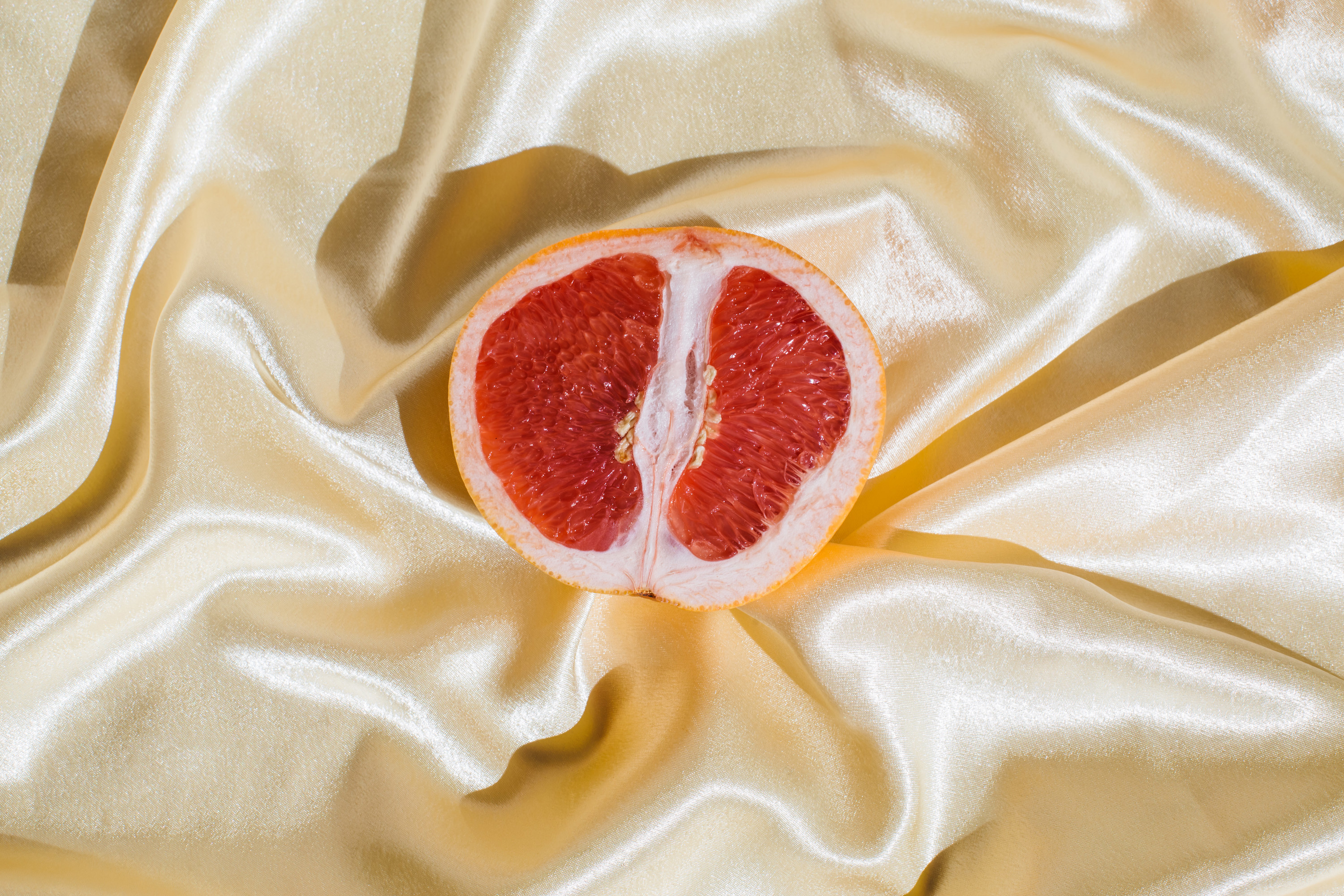 A stock image of a grapefruit on a silky backdrop