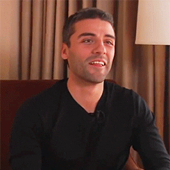 Oscar Isaac sitting for an interview and licking his lips