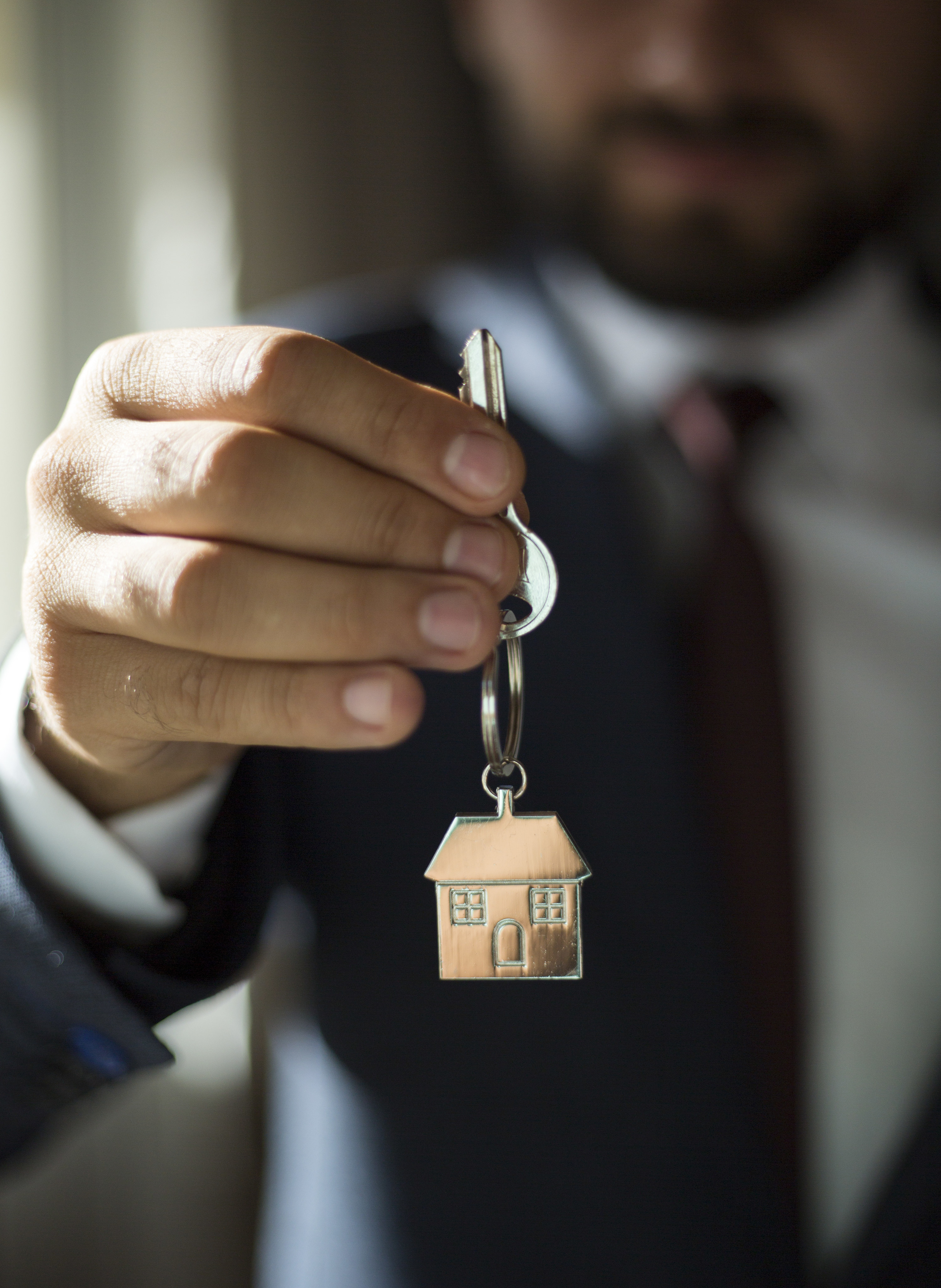 Real estate agent giving house keys