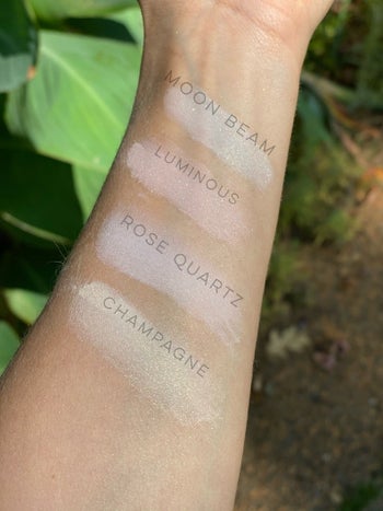 A wrist showing four pigmented shades of gold, pink, peach, and white 