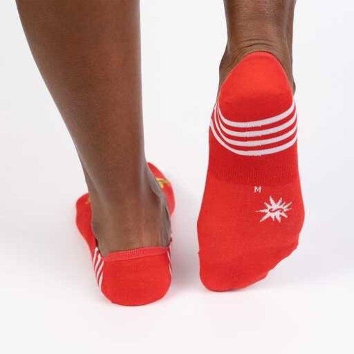 Model wearing red taco cat socks, back