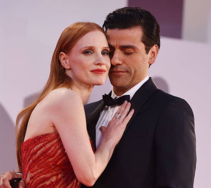 Jessica Chastain leaning into Oscar Isaac&#x27;s chest on the red carpet