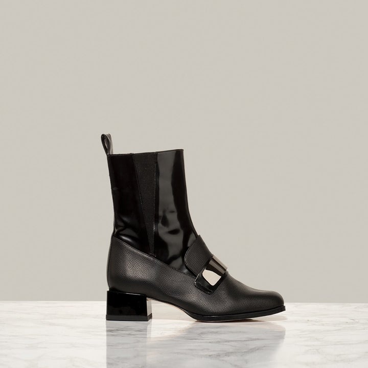 black loafer-style heeled boot shot from the side
