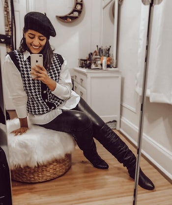 Daily News | Online News reviewer wearing the black and white vest with a blouse and leather black pants