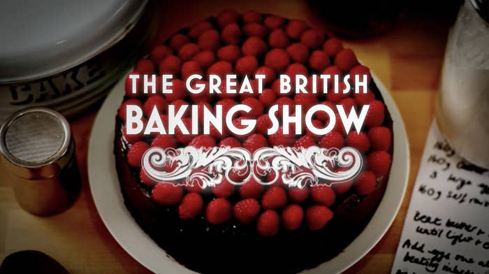 the title card for The Great British Baking Show which features a cake topped with raspberries