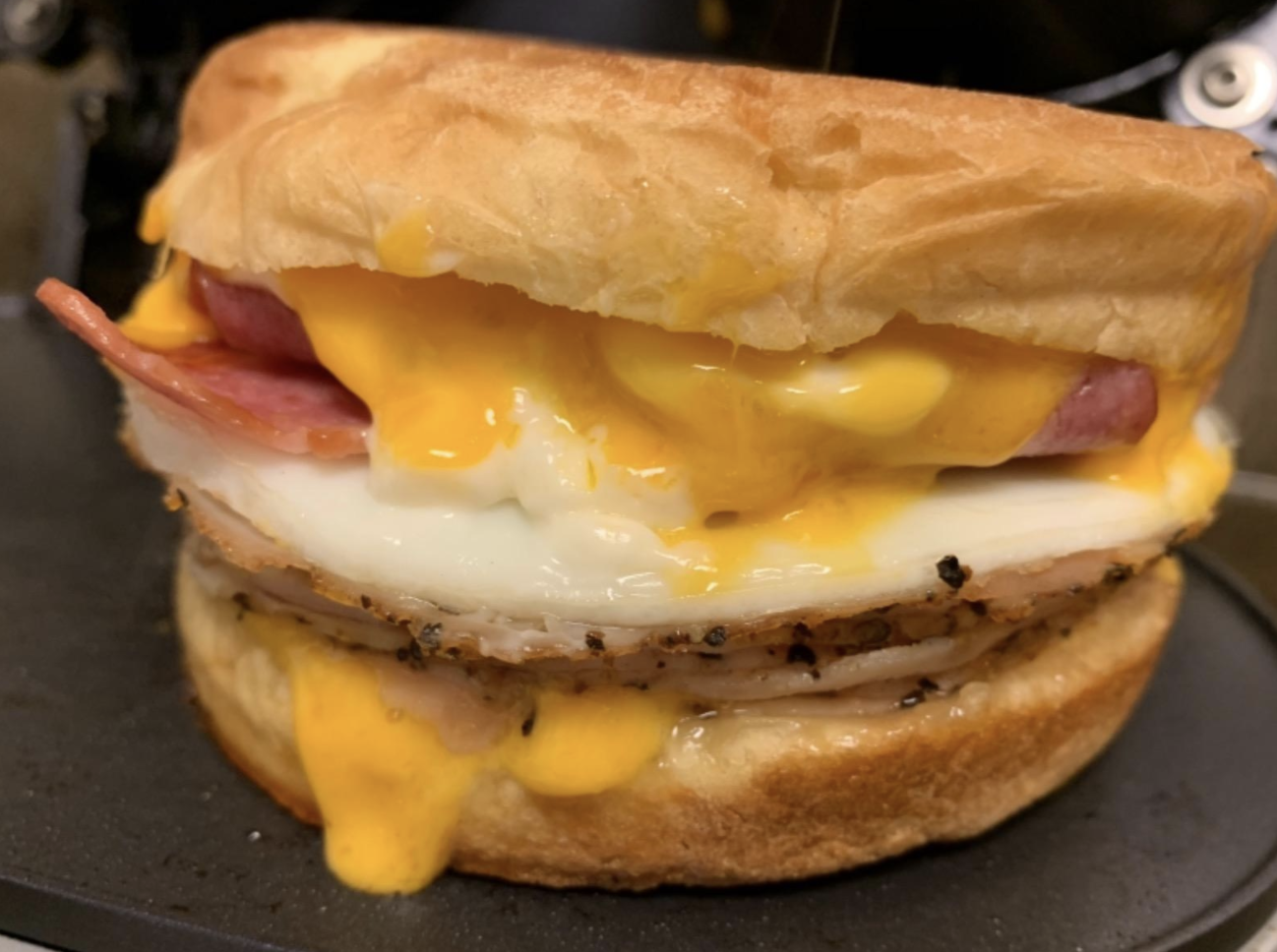breakfast sandwich with an english muffin egg cheese and bacon