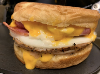breakfast sandwich with an english muffin egg cheese and bacon