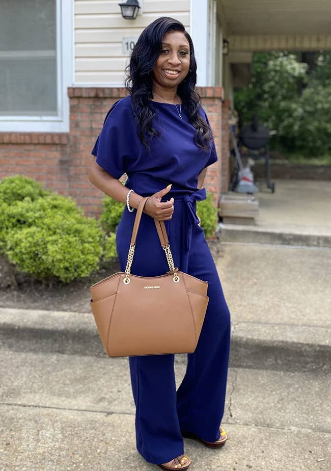 reviewer in short-sleeve wide-leg jumpsuit with belt on the front