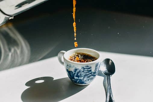 Coffee being poured into cup.