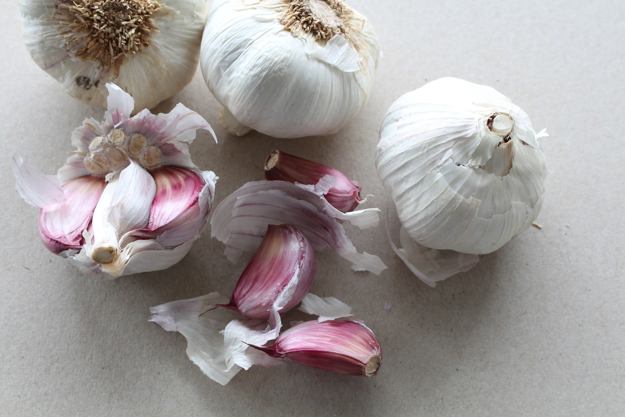 Garlic bulbs, some half peeled