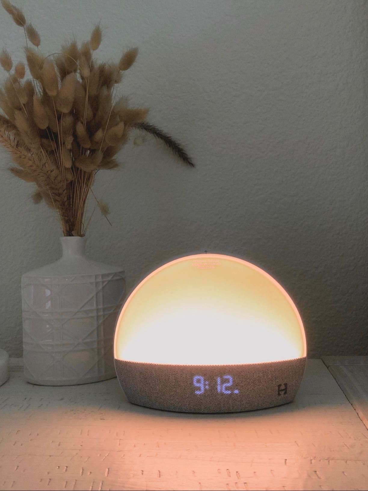 reviewer photo of a sunrise clock lit up