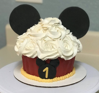 a giant mickey themed birthday cupcake