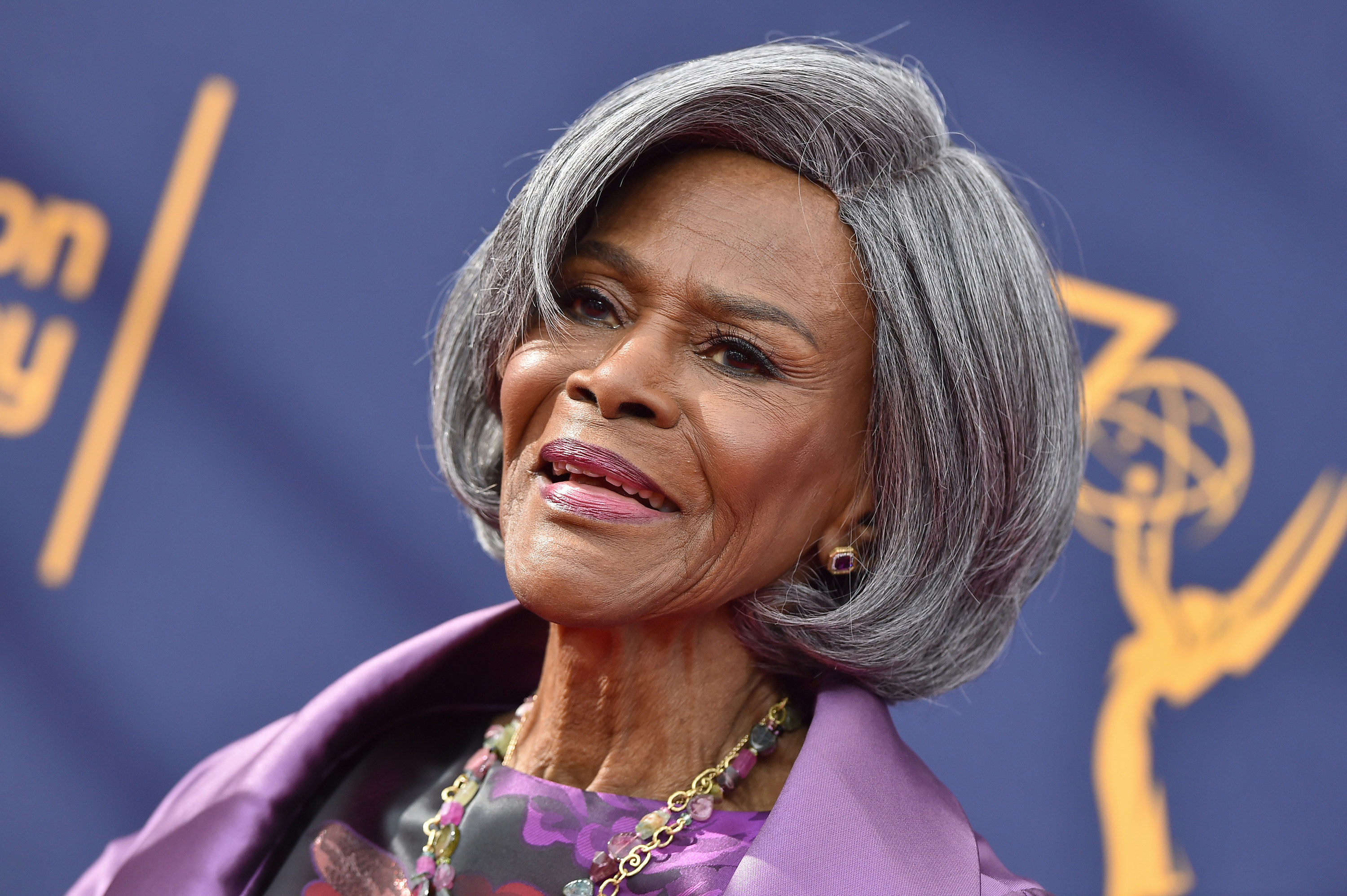 Cicely Tyson wears a silk blazer and a necklace while posing for the camera.