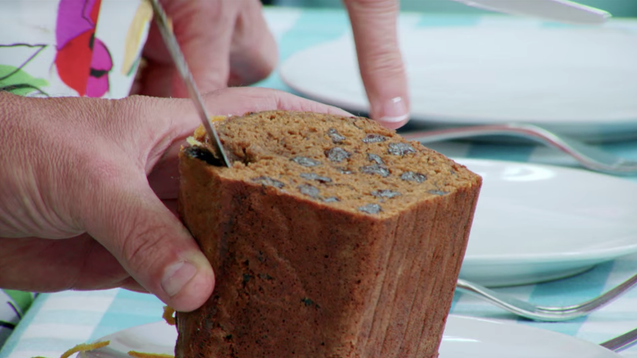 Paul pushing a knife into the raw parts of the bake