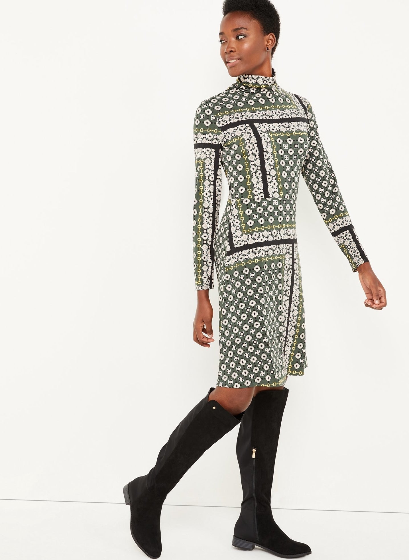 The long sleeve dress paired with knee-high black boots