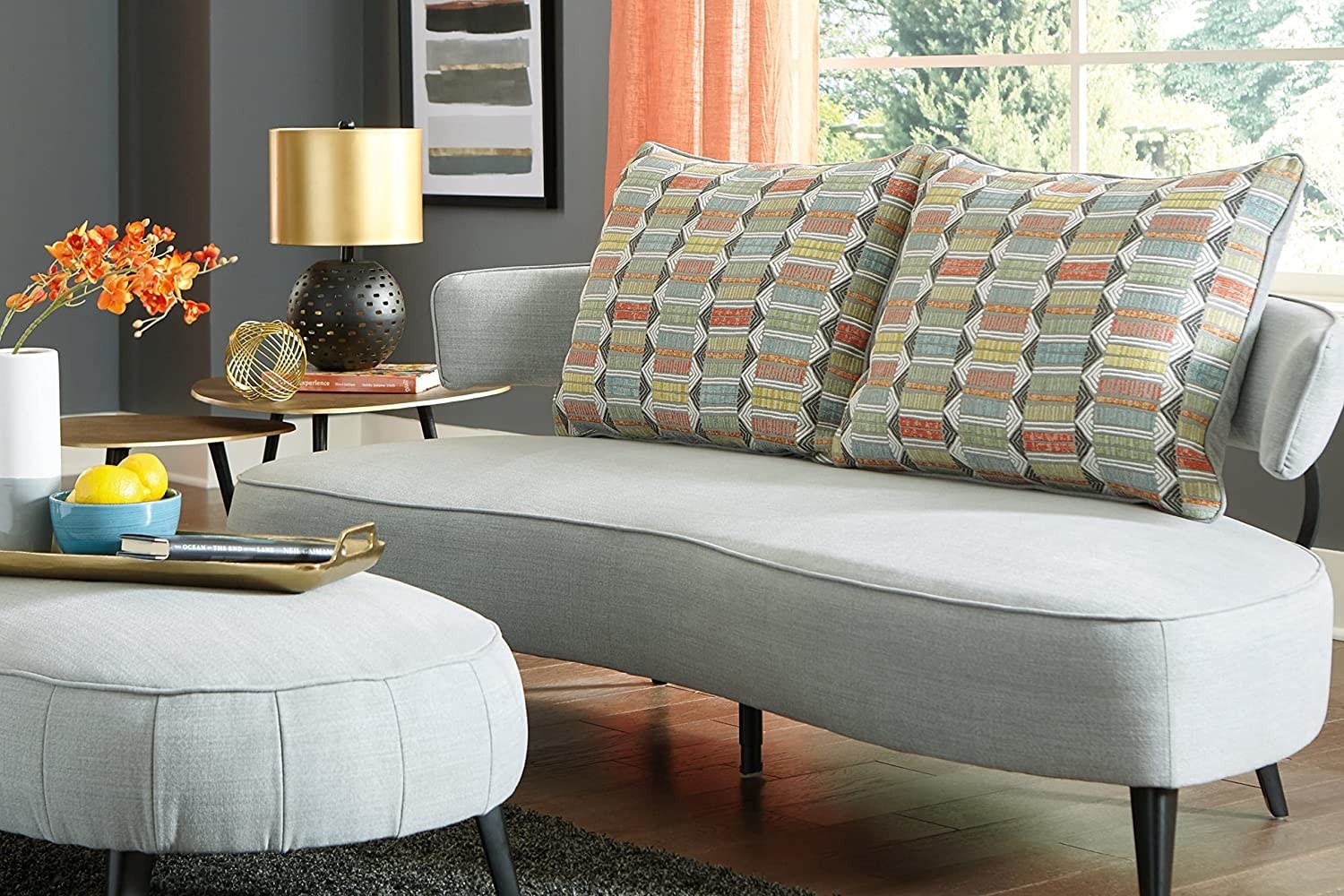 A grey couch in a colorful room