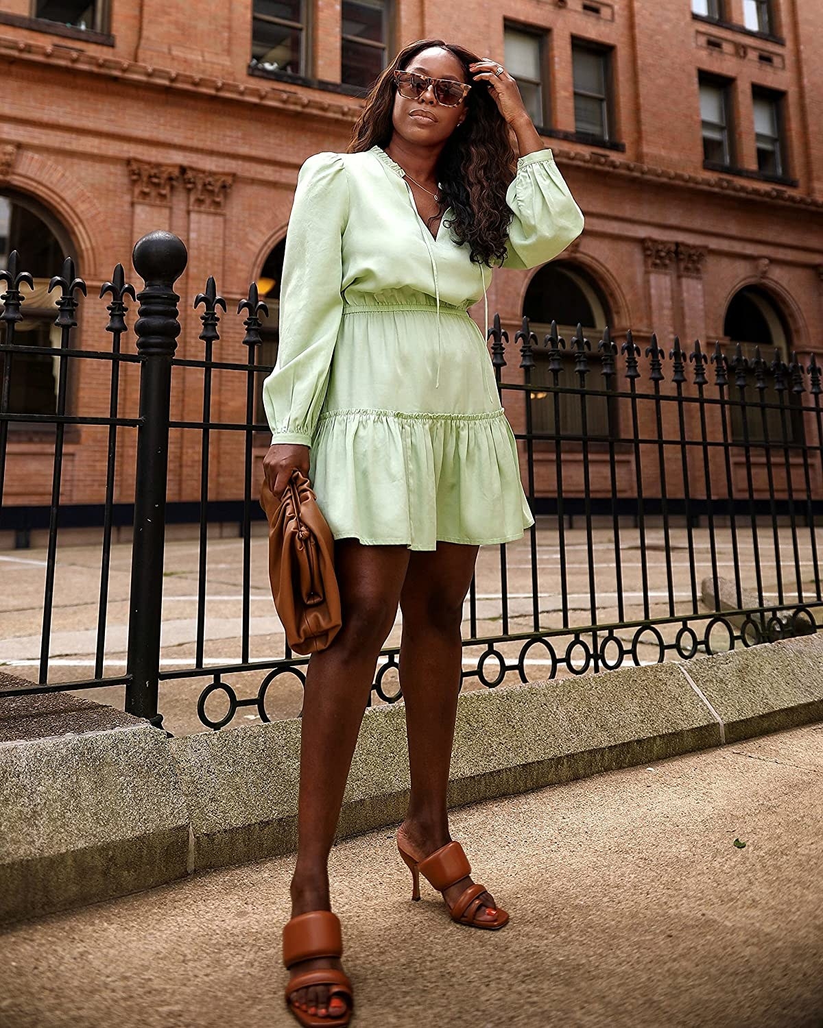 model in mint green v-neck long-sleeve mini dress and brown heeled sandals