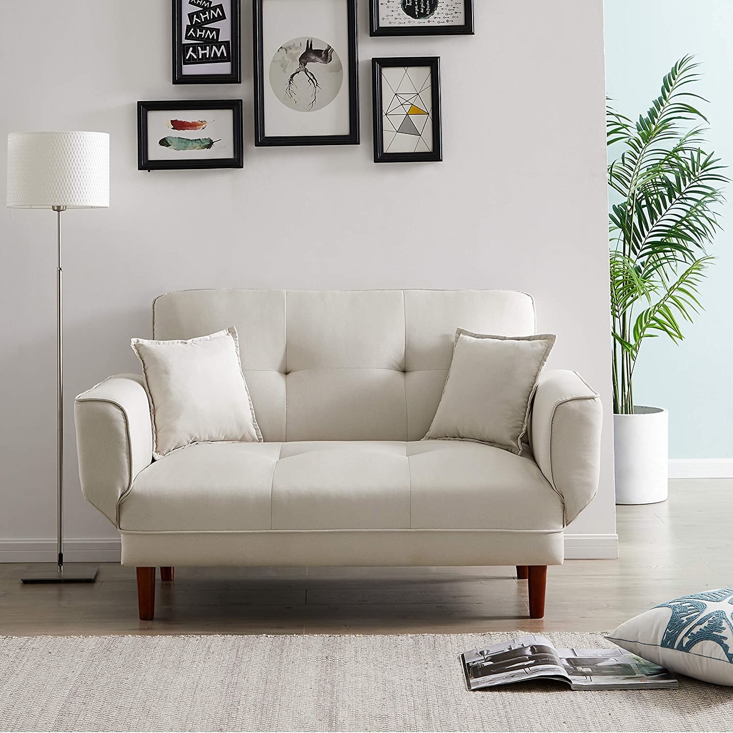 A white loveseat in a white room