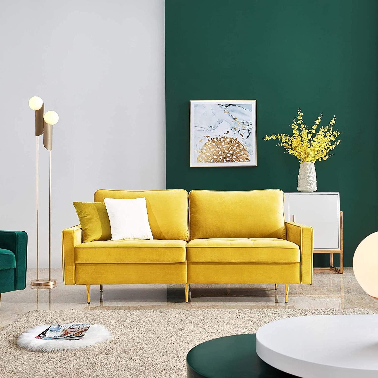 A yellow couch in a green room with white cushion