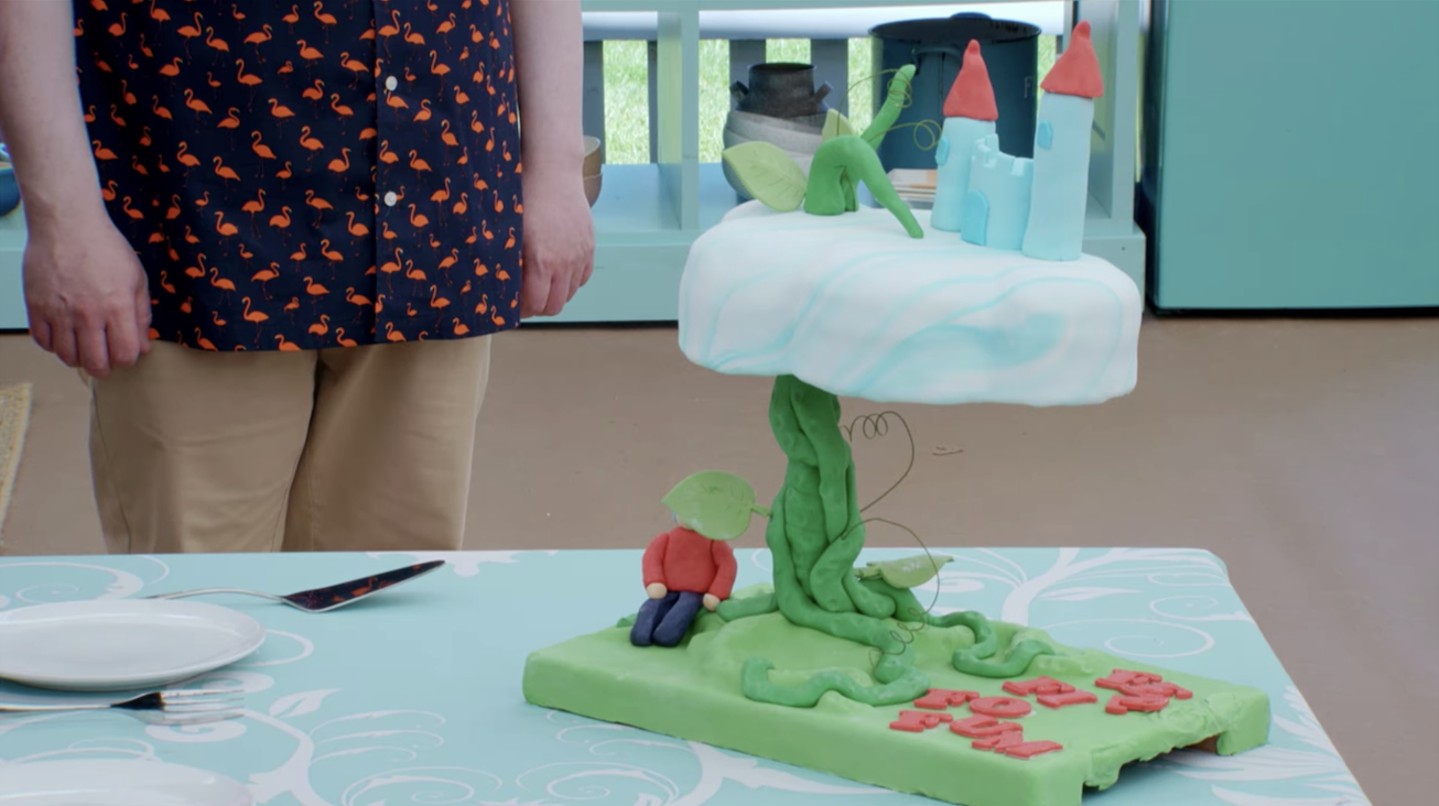a cake composed of a cloud with a castle on top, all on top of a fondant beanstalk