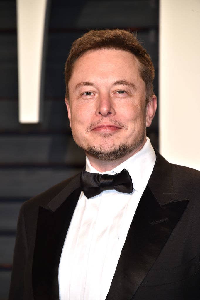 Elon poses for photographers at an event in a tux