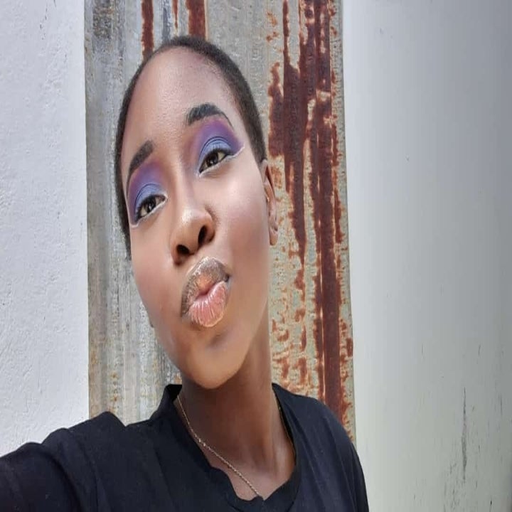 a reviewer showing off a purple eye look made from the palette